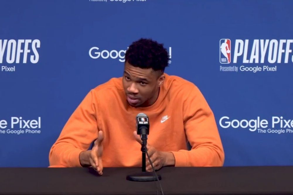 Image of NBA star Giannis Antetokounmpo giving a press conference after a loss.